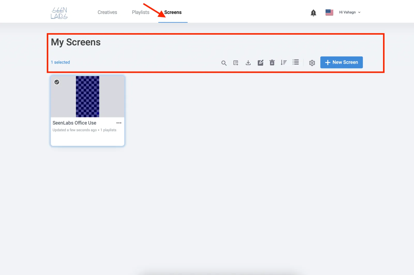 The Screens tab of the dashboard. An arrow points at Screens in the top bar and a highlighted box surrounds the My Screens heading and its toolbar, which ends in a blue New Screen button. One screen card is below, named SeenLabs Office Use, showing a portrait thumbnail and the line Updated a few seconds ago, 1 playlists.